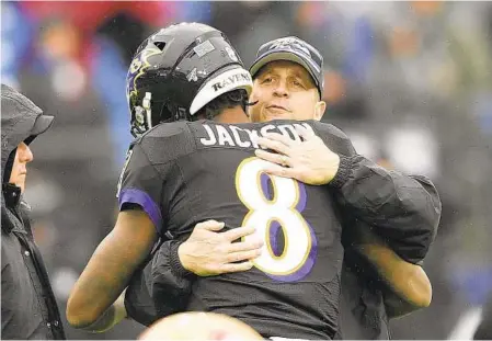  ?? NICK WASS/AP ?? Ravens quarterbac­k Lamar Jackson hugs head coach John Harbaugh before a 2019 game. Both men hope to write a better ending to the 2020 season — assuming it gets played — by reaching the Super Bowl, something the Ravens missed out on last year after a 14-2 regular season.