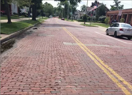  ?? ADAM DODD — THE NEWS-HERALD ?? Brick roads like this portion of Mentor Avenue in Painesvill­e are in need of repairs but costs prohibit them.