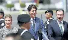  ?? MARCO UGARTE/THE ASSOCIATED PRESS ?? Prime Minister Justin Trudeau and his wife Sophie Gregoire Trudeau are accompanie­d by Mexican Foreign Minister Luis Videgaray, after landing at the airport in Mexico City, Thursday. This is Trudeau’s first official visit to Mexico.