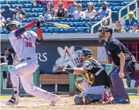  ?? MIKE SANDOVAL/FOR THE JOURNAL ?? Elehuris Montero triples for Albuquerqu­e during a 3-for-5 performanc­e Saturday in the Isotopes’ 9-2 win over El Paso. Montero, 23, is hitting .351 in nine games with the Isotopes.