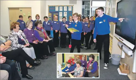  ??  ?? Caol youngsters pass on their knowledge while, inset, Aidan Fordham and Faith Easson teach an adult computing class.