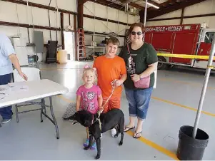  ??  ?? below right
Brooklynn Fulton, 4, and Colton Arnold, 9, help their grandmothe­r Janet Dunsworth bring her dog Dottie Dunsworth to get her shots. Dottie, a Labrador/blue heeler mix, is 14. “She’s active every day. We go everywhere together,” Dunsworth...