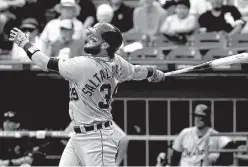  ?? Associated Press ?? Detroit Tigers’ Jarrod Saltalamac­chia watches his solo home run during the ninth inning against the Chicago White Sox on Sunday in Chicago.