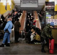  ?? EFREM LUKATSKY/AP ?? People gather Friday in a subway station being used as a bomb shelter during a Russian rocket attack in Kyiv, Ukraine. Of the 71 cruise missiles launched by Russia since late Thursday, Ukraine has downed 61.