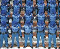  ?? ELAINE THOMPSON / AP ?? Patrol cadets bow their heads in prayer at their graduation ceremony in Olympia, Washington state, on Wednesday. They had gone through nearly six months of field and academy training.