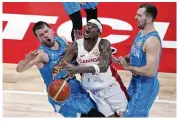  ?? AP ?? Shai Gilgeous-Alexander (center) collides with Luka Doncic (left) as Zoran Dragic defends at a Basketball World Cup quarterfin­al game in Manila, on Wednesday.