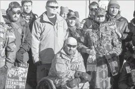  ??  ?? VETERANS at the protest site. “You can’t allow big money to come in and rip up the Constituti­on in the faces of America’s oldest citizens,” one veteran said.