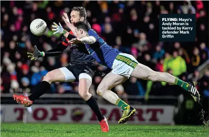  ??  ?? FLYING: Mayo’s Andy Moran is tackled by Kerry defender Mark Griffin