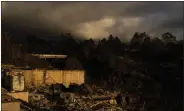  ?? JAE C. HONG — THE ASSOCIATED PRESS FILE ?? Clouds hang over a home destroyed in a wildfire in Kula, Hawaii, on Aug. 15.