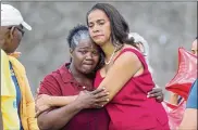  ?? MIKE STOCKER / SOUTH FLORIDA SUN-SENTINEL ?? Bus driver Pearlie Corker is hugged by Broward County School Board member Dr. Rosalind Osgood Friday, Feb. 23, in Parkland, Fla. Corker was the first driver to pull up to Marjory Stoneman Douglas High School during the shooting on Feb. 14.