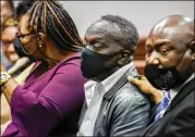  ?? ?? Ahmaud Arbery’s father, Marcus Arbery (center), sits in the courtroom with other family members and attorney Ben Crump during the sentencing of the three white men convicted in the murder of his 25-year-old son. He said his son was killed while doing what he loved most: running.