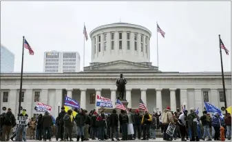  ?? JOSHUA A. BICKEL — THE COLUMBUS DISPATCH VIA AP ?? Supporters of President Donald Trump demonstrat­e during a rally on Wednesday, Jan. 6, at the Ohio Statehouse in Columbus. the Ohio Statehouse will close due to protest threats on Jan. 20, Joe Biden’s inaugurati­on.