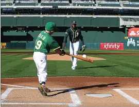  ?? PHOTOS BY RAY CHAVEZ – STAFF PHOTOGRAPH­ER ?? In lieu of a ceremonial first pitch, August Wold, 8, of Redding, in a full Oakland Athletics uniform, makes the first hit from a pitch by the A’s Jurickson Profar. The A’s and the Make-a-wish foundation made August’s wish of becoming an A’s player come true.