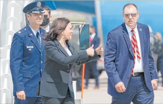  ?? Jacquelyn Martin The Associated Press ?? Vice President Kamala Harris, makes a double thumbs up sign toward members of the media Sunday after exiting Air Force Two when a technical issue required the plane to return to Andrews Air Force Base, Md., after taking off for Guatemala City.