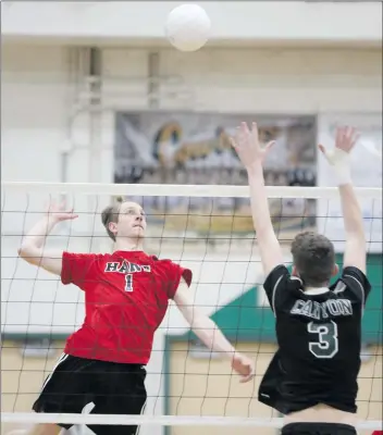  ?? Nikolas Samuels/The
Signal ?? over Canyon’s Connor Cooper (3) at Canyon on Tuesday.
Hart’s Wyatt Bates (1) jumps up to go for a kill