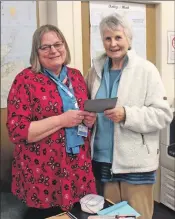  ??  ?? Jane MacDonald recieves a gift from Meryl Kennedy on behalf of the village on her last day as Plockton librarian.