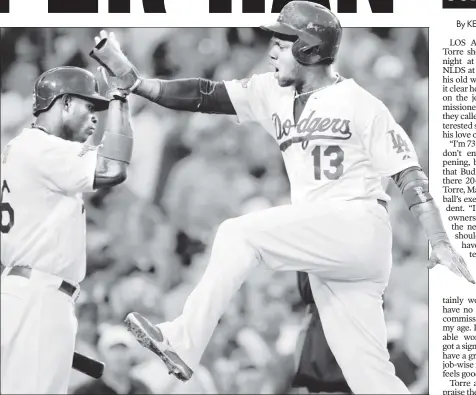  ?? EPA ?? FLYING HIGH: Hanley Ramirez (right) leaps to high-fiveDodger­s teammate Yasiel Puig after scoring in the third inning of Los Angeles’ 13-6 win over the Braves in Game 3 of the NLDS on Sunday night.