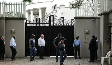  ?? Picture: Matthews Baloyi/African News Agency (ANA) ?? SEARCHING FOR CLUES: The Asset Forfeiture Unit yesterday descended on the Guptas’ luxurious Saxonwold home with a restraint order to seize the family’s multimilli­on-rand assets.