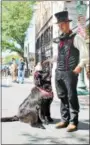  ??  ?? A costumed festival-goer and his dog.