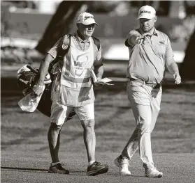  ?? Abbie Parr / Getty Images ?? Matthew NeSmith, the first-round leader with Mark Hubbard after shooting a 63, walks with his caddie at the Waste Management Phoenix Open on Thursday.