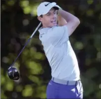  ?? PATRICK RAYCRAFT — HARTFORD COURANT VIA AP ?? Rory McIlroy watches his drive from the 13th tee on Thursday.