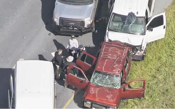  ??  ?? Law enforcemen­t personnel investigat­e the scene where the Texas bombing suspect blew himself up on the side of a highway north of Austin in Round Rock, Texas. — Reuters photo