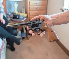  ?? HEIDI DE MARCO/KAISER HEALTH NEWS ?? Delmar Scroughams of Rexburg, Idaho, has a revolver and shotguns in his firearms collection. His wife, Verg, restricted his access to the guns after he showed signs of dementia.