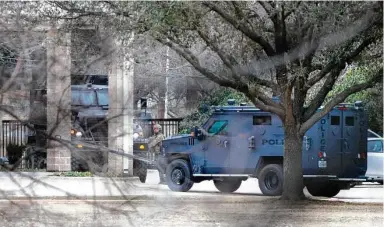  ?? Lynda M. Gonzalez / Associated Press ?? Law enforcemen­t teams stage near Congregati­on Beth Israel while conducting SWAT operations in Colleyvill­e on Saturday afternoon. Authoritie­s said a man took hostages during services at the synagogue.