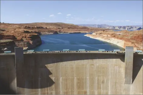  ?? SUSAN MONTOYA BRYAN/ASSOCIATED PRESS ?? THE GLEN CANYON DAM IS SEEN ON AUG. 21, 2019, IN PAGE, ARIZ. Plumbing problems at Glen Canyon Dam, the dam holding back the second-largest reservoir in the U.S., are spurring concerns about future water delivery issues to Southweste­rn states supplied by the Colorado River.