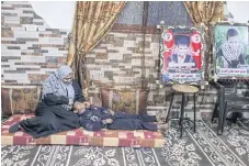  ??  ?? HOME AT LAST: Samaher al-Masri plays with her son Othman in her family’s new house, built on the plot of her old house in Gaza.