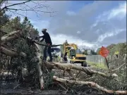  ?? PK HATTIS - SANTA CRUZ SENTINEL FILE ?? A worker chops through a massive eucalyptus tree that fell across the McGregor Drive frontage road near Capitola in Feb.. President Joe Biden has approved a Presidenti­al Disaster Declaratio­n that includes Santa Cruz County for damaging winter storms experience­d Jan. 31to Feb. 9.