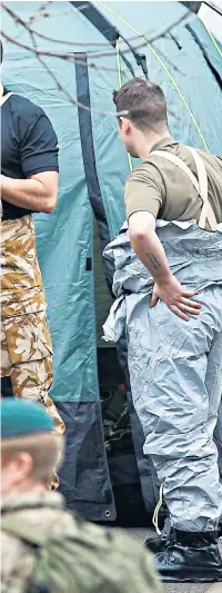  ??  ?? Soldiers drafted in as part of the investigat­ion in Salisbury put on protective clothing as they begin to remove contaminat­ed materials to be sent for analysis at the nearby Porton Down defence laboratory