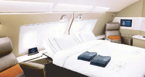  ??  ?? The new Singapore Airlines A380 First Class Suites feature double beds with seats upholstere­d in Poltrona Frau leather and pajamas and bed linens by Lalique. The first of five new A380s will start flying on Dec. 18 to Sydney as its first route.
