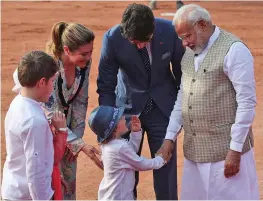  ?? — AP ?? Prime Minister Narendra Modi interacts with his Canadian counterpar­t Justin Trudeau’s youngest son Hadrien as other family members listen in during a ceremonial reception in New Delhi on Friday.