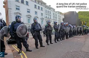  ?? TAYFUN SALCI ?? A long line of UK riot police guard the Iranian embassy