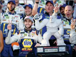  ?? ASSOCIATED PRESS ?? CHASE ELLIOTT (FRONT LEFT) poses with the trophy in Victory Lane after he won a NASCAR Cup Series auto race, Sunday at Dover Internatio­nal Speedway in Dover, Del.