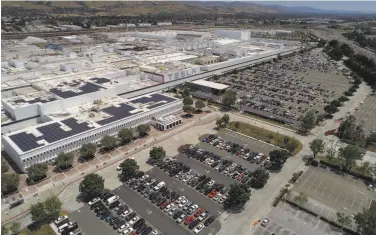  ?? Carlos Avila Gonzalez / The Chronicle ?? With its Fremont car plant reopening, employees are being told that they must return starting Friday.