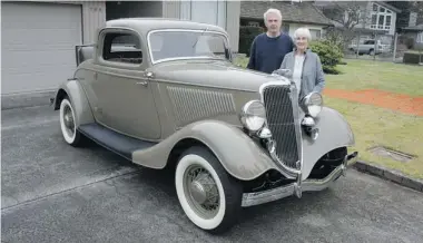  ??  ?? Ross and Joyce Blewett with their meticulous­ly restored 1934 Ford coupe, with its greyhound hood ornament.