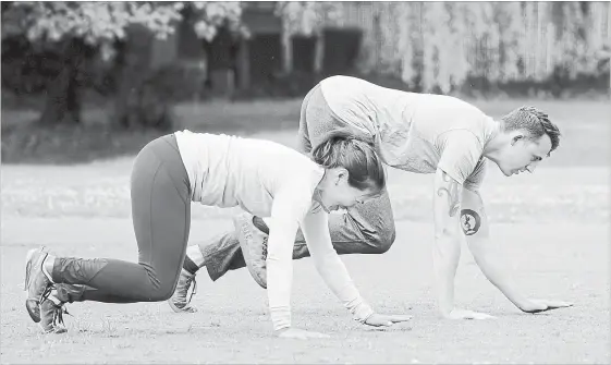  ?? PHOTOS BY BETTINA HANSEN
SEATTLE TIMES ?? Nicole Tsong works with trainer Kyle Long for a crawling and locomotion workout