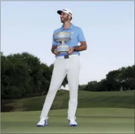  ?? ERIC GAY — THE ASSOCIATED PRESS ?? Dustin Johnson holds his trophy as he waits to pose for photos after defeating Jon Rahm of Spain at the Dell Technologi­es Match Play golf tournament at Austin County Club, Sunday in Austin, Texas.