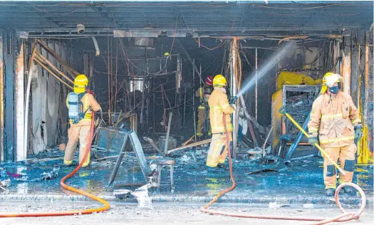  ?? Photo / Kathy Bland ?? Firefighte­rs tackle the blaze at the Forget Me Not Opportunit­y Shop in Paeroa.