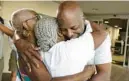  ?? CARLINE JEAN/ SOUTH FLORIDA SUN SENTINEL ?? Sidney Holmes, 57, hugs his mom and aunt as he leaves the Broward County Jail on Monday. Holmes was exonerated after serving more than 34 years of a 400-year sentence for a 1988 armed robbery.