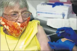  ?? ROGELIO V. SOLIS — THE ASSOCIATED PRESS ?? Linda Busby, 74, stiffens up as she receives the Johnson & Johnson COVID-19 vaccine at the Aaron E. Henry Community Health Service Center in Clarksdale, Miss., on Wednesday.