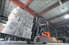  ?? GERRY BROOME — THE ASSOCIATED PRESS ?? A forklift operator loads absentee ballots for mailing at the Wake County Board of Elections as preparatio­ns for the upcoming election are ongoing in Raleigh, N.C.