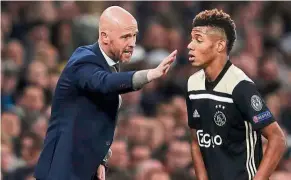  ?? — AFP ?? It’s this way: Ajax coach Erik ten Hag (left) giving instructio­ns to striker David Neres during the Champions League semi-final first-leg match against Tottenham on Tuesday.