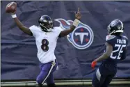  ?? MARK ZALESKI - THE ASSOCIATED PRESS ?? Baltimore Ravens quarterbac­k Lamar Jackson (8) celebrates after scoring a touchdown on a 48-yard run against the Tennessee Titans in the first half of an NFL wild-card playoff football game Sunday, Jan. 10, 2021, in Nashville, Tenn. At right is Titans cornerback Kristian Fulton (26).