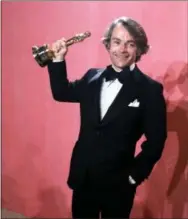  ?? THE ASSOCIATED PRESS ?? In this file photo, John C. Avildsen shows off the Oscar he won for best director for “Rocky,” at the Academy Awards in Los Angeles. Avildsen, who directed “Rocky” and “The Karate Kid,” the hugely successful underdog fables that went on to become...