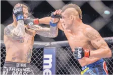  ?? ROBERTO E. ROSALES/JOURNAL ?? Albuquerqu­e’s Diego Sanchez, right, lands a punch against Ross Pearson during their 2014 fight at Tingley Coliseum.