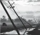  ?? MATT SLOCUM/AP ?? Downed power lines slump over a road in the aftermath of Hurricane Ida, Friday in Reserve, La.