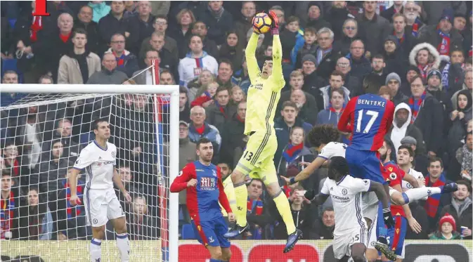  ?? — AFP ?? LONDON: Chelsea’s Belgian goalkeeper Thibaut Courtois (C) jumps to save a shot by Crystal Palace’s Zaire-born Belgian striker Christian Benteke during the English Premier League football match between Crystal Palace and Chelsea at Selhurst Park in...